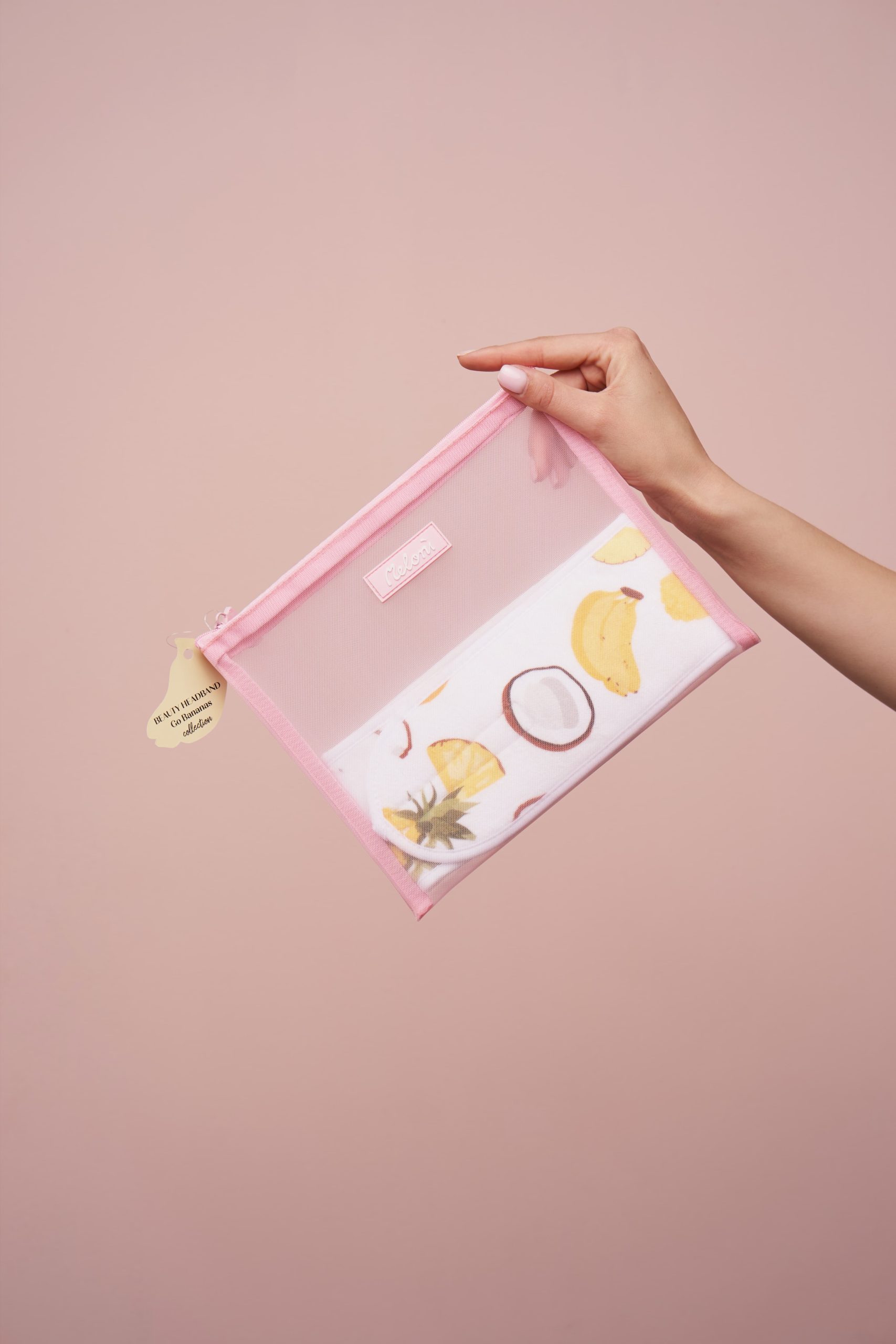 Hand holding pink mesh pouch