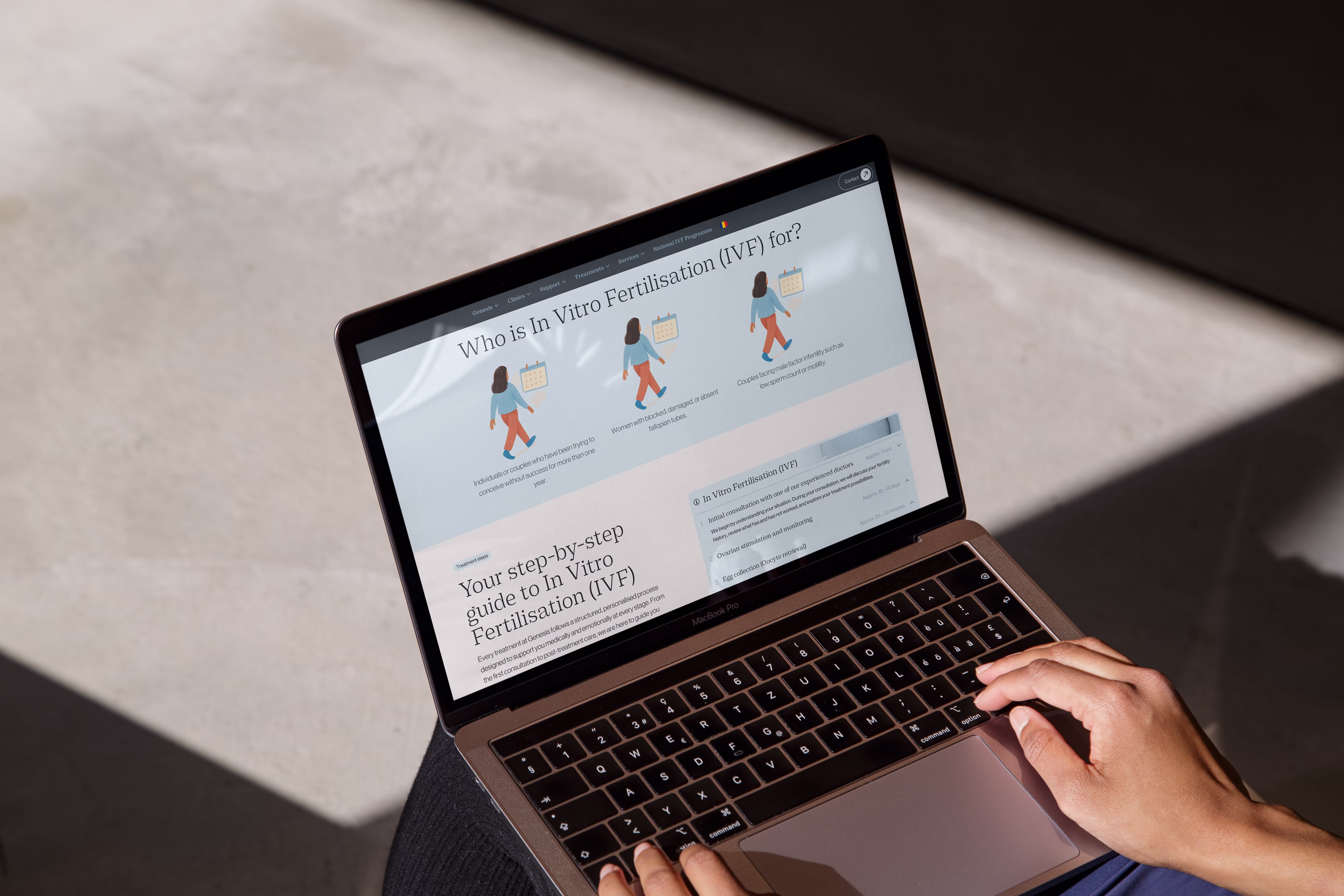 Genesis Athens website detail on a laptop showing fertility service content